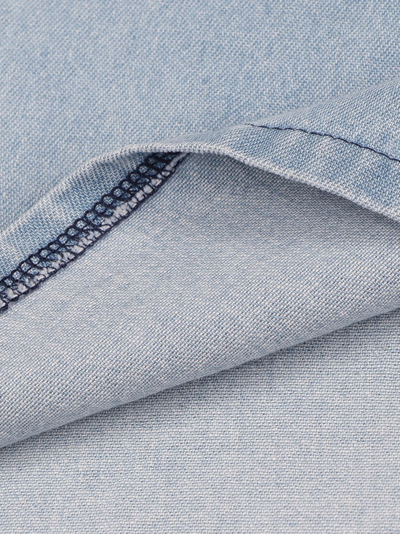 Close-up of blue denim fabric with a visible seam.