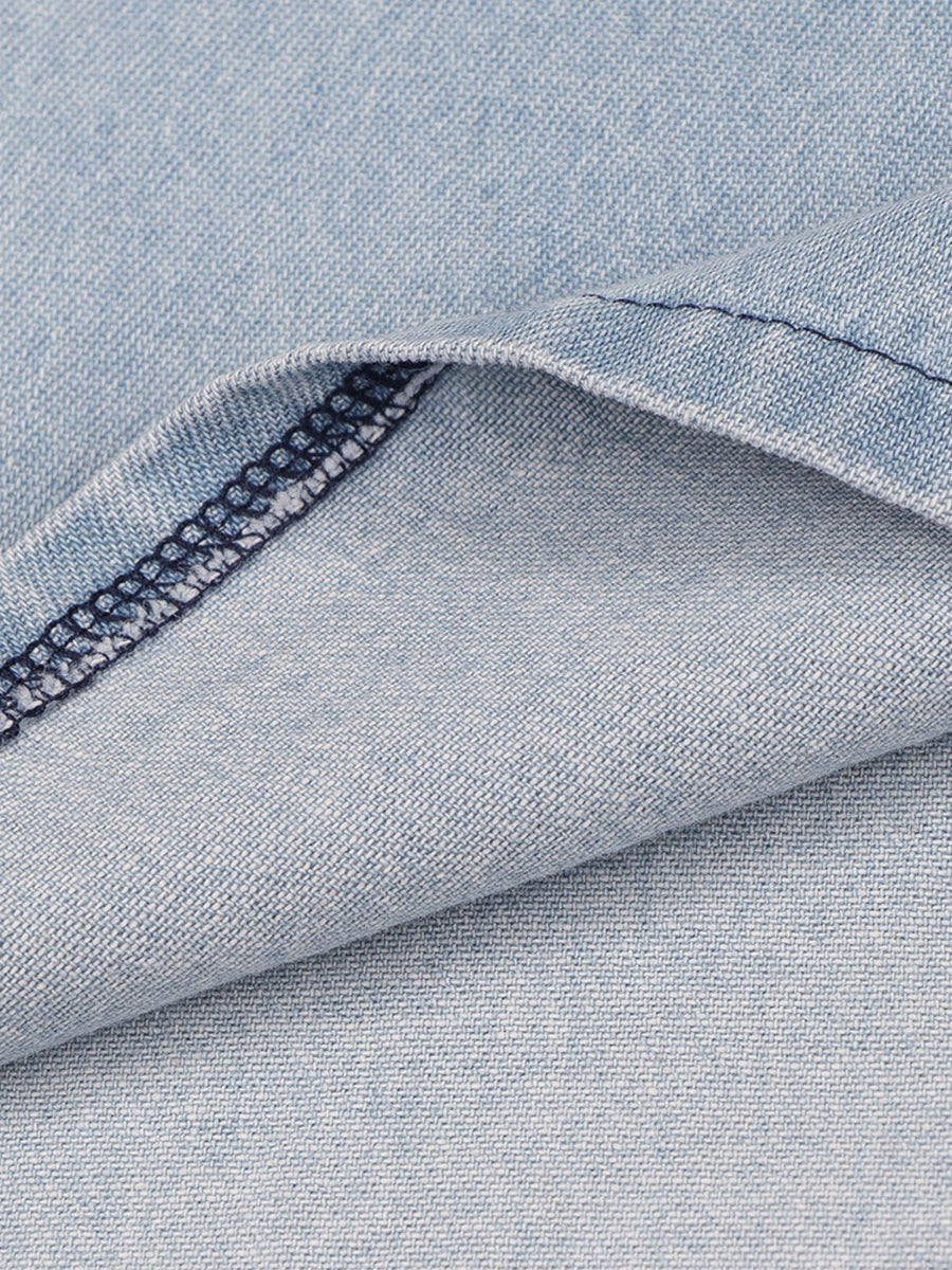 Close-up of blue denim fabric with a visible seam.