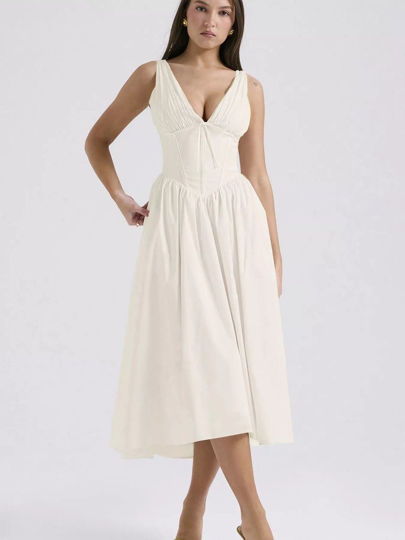 Woman wearing a white dress on a plain background