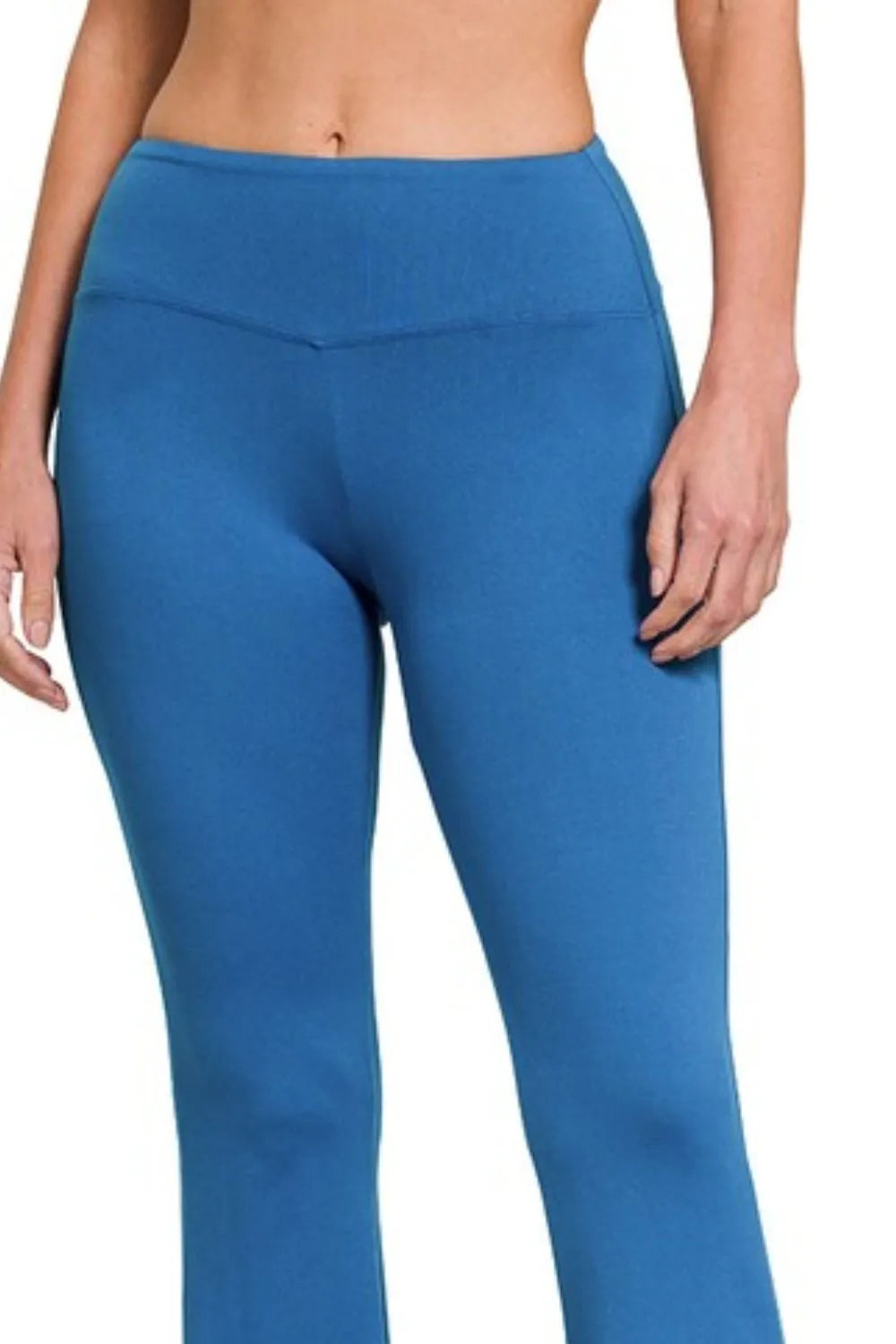 Blue leggings worn by a person on a white background
