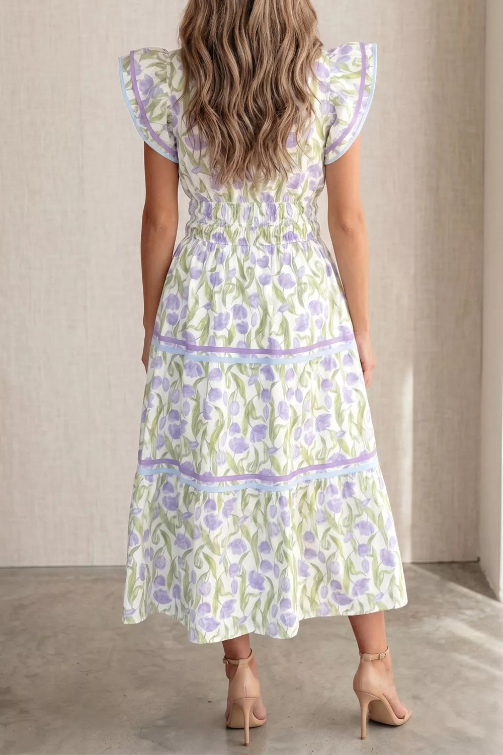 Woman wearing a floral dress with a neutral background