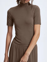Brown turtleneck top and skirt set on a white background