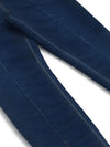 Close-up of blue denim fabric with visible stitching on a white background