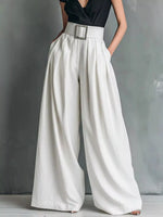 White wide-leg pants worn with a black top on a gray background
