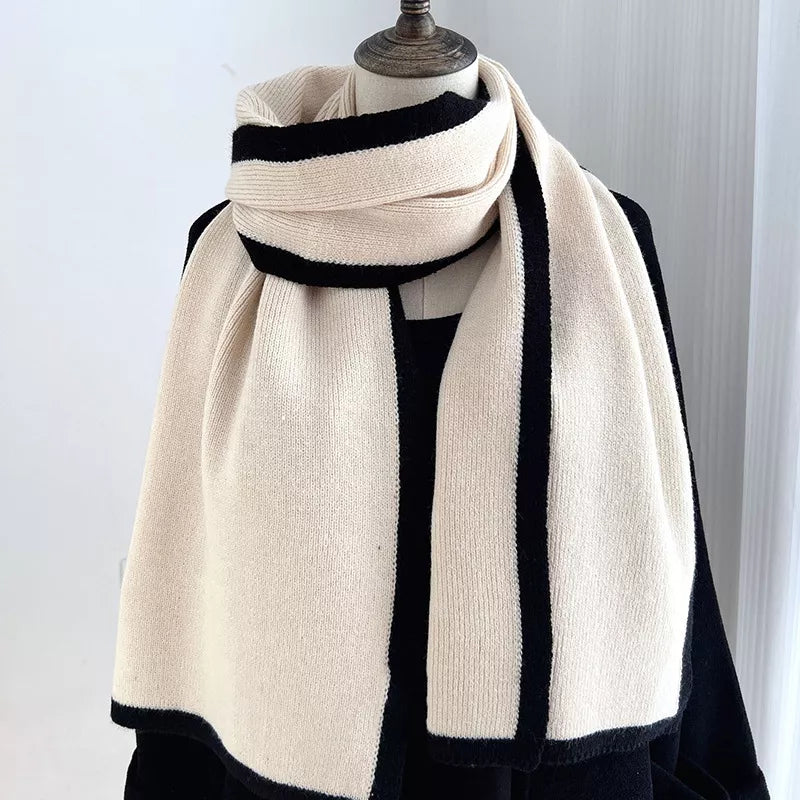 Mannequin wearing a cream and black scarf against a white background