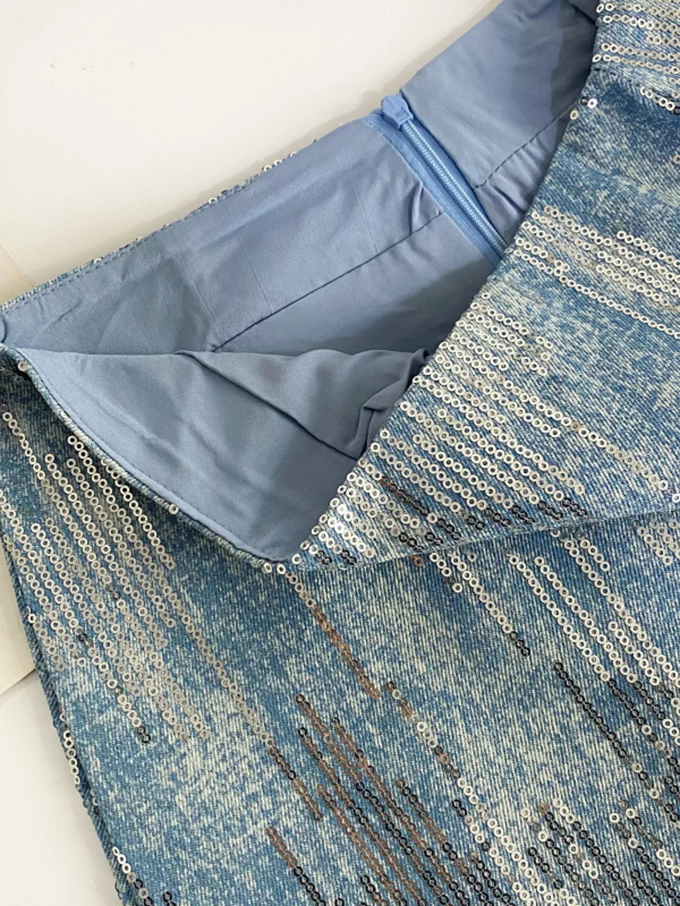Close-up of a blue fabric with a textured pattern on a white background