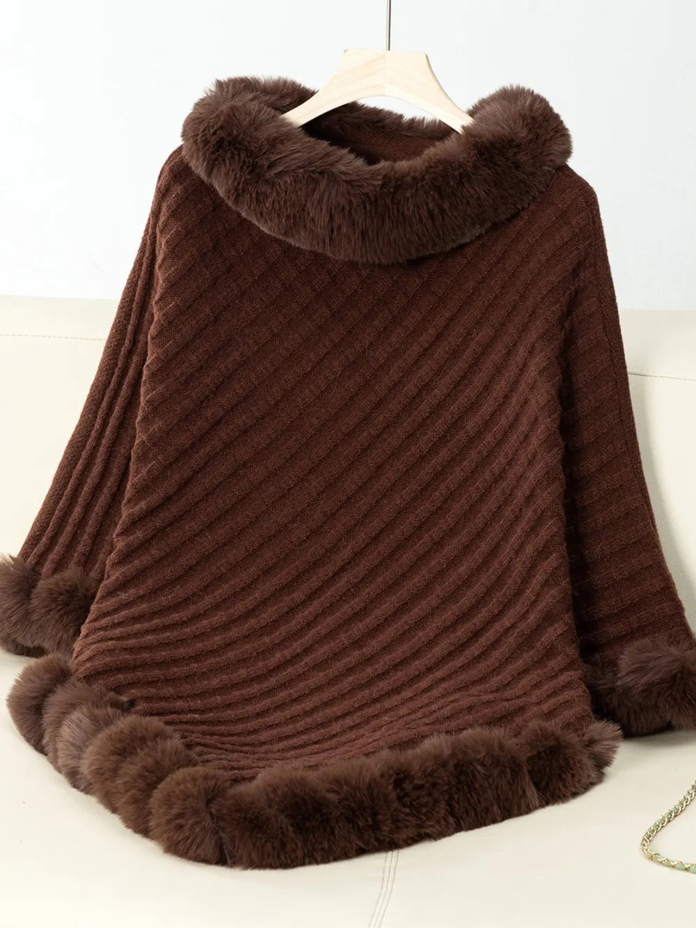 Brown fur-trimmed poncho on a white background