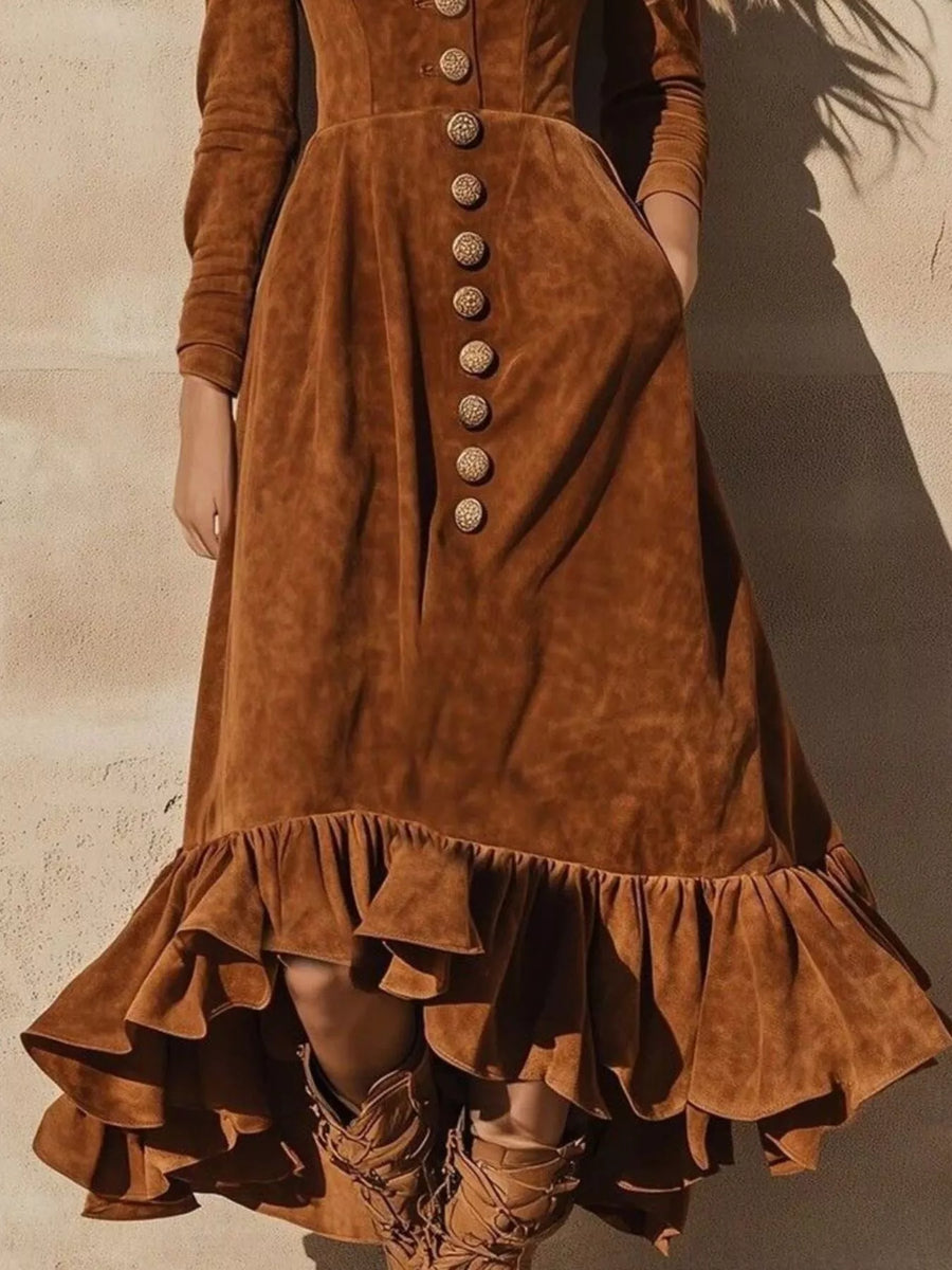 Brown suede dress with button details and ruffled hem on a neutral background