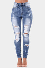 Distressed blue jeans on a white background