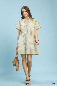 Woman wearing a beige dress with a textured pattern on a light blue background