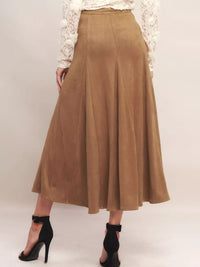 Brown suede skirt worn by a person on a white background