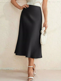 Person wearing a black skirt with a white background
