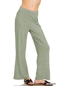 Green wide-leg pants worn by a person on a white background
