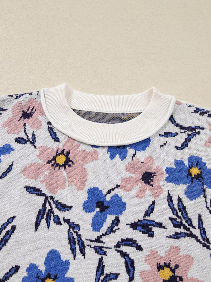 Floral patterned sweater with a white collar on a beige background