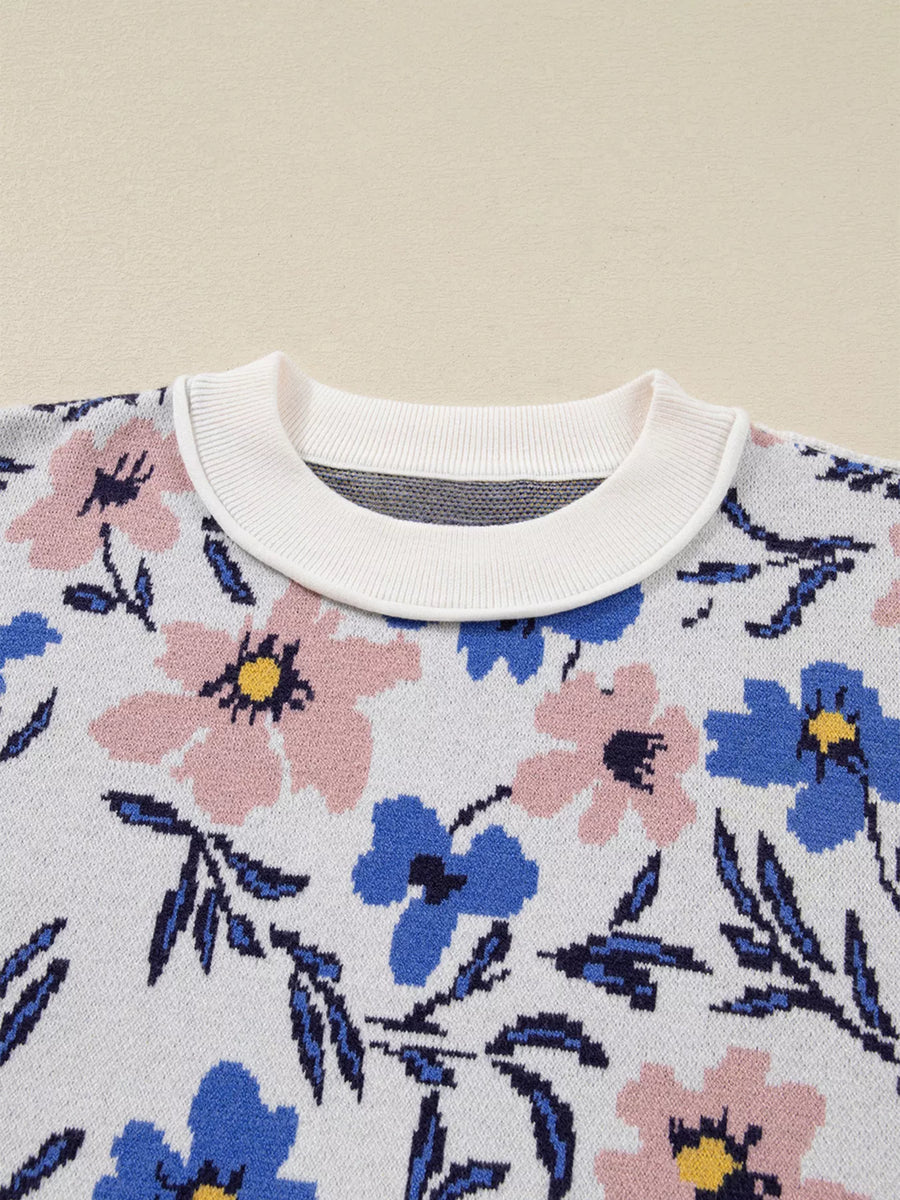 Floral patterned sweater with a white collar on a beige background
