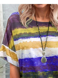 Person wearing a colorful striped shirt with a necklace