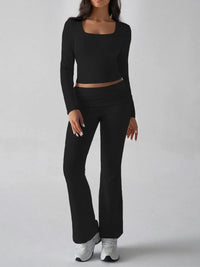 Person wearing a black long-sleeve top and black pants on a white background