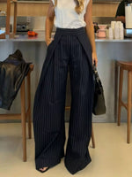 Person wearing pinstripe pants in a casual indoor setting