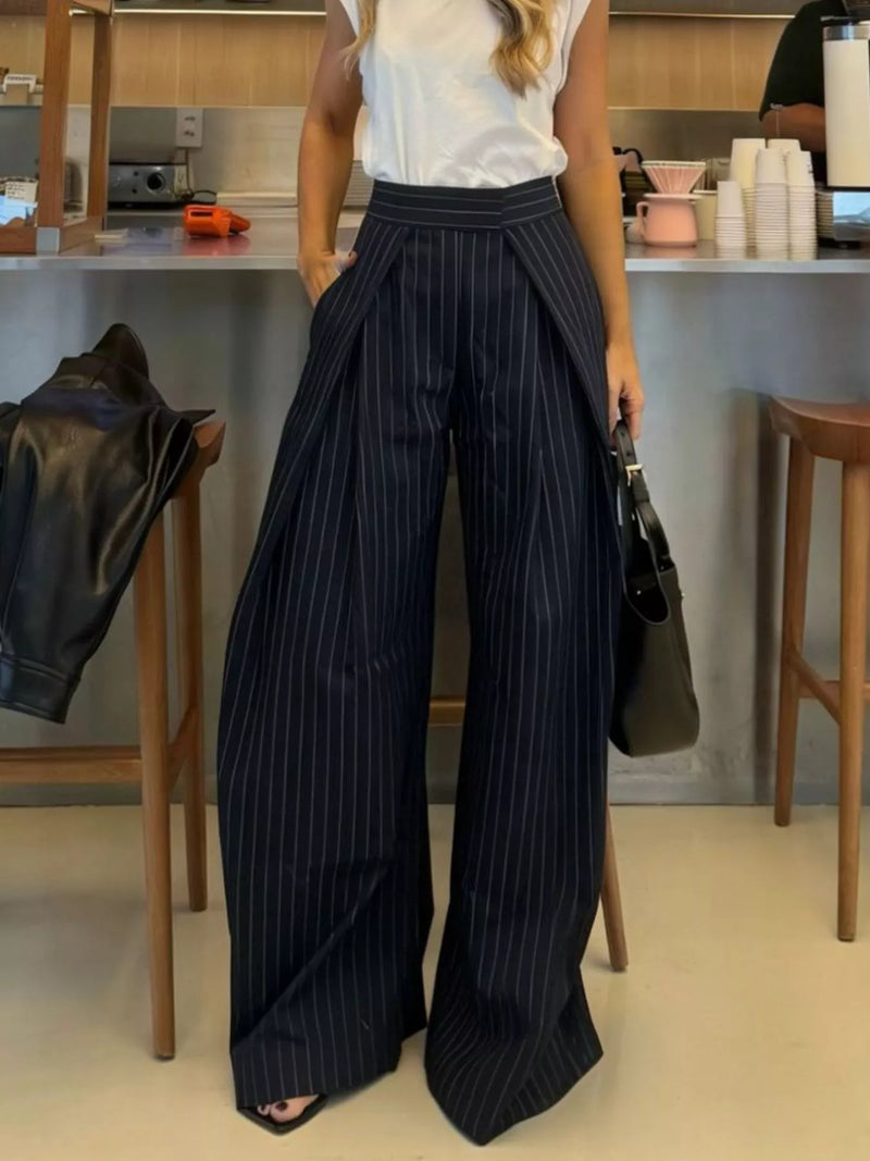 Person wearing pinstripe pants in a casual indoor setting