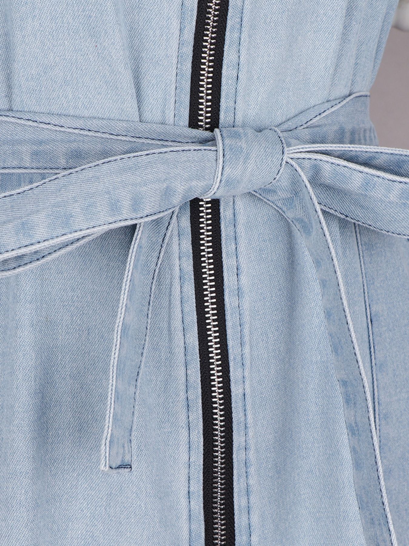 Light blue denim dress with a belt and zipper detail