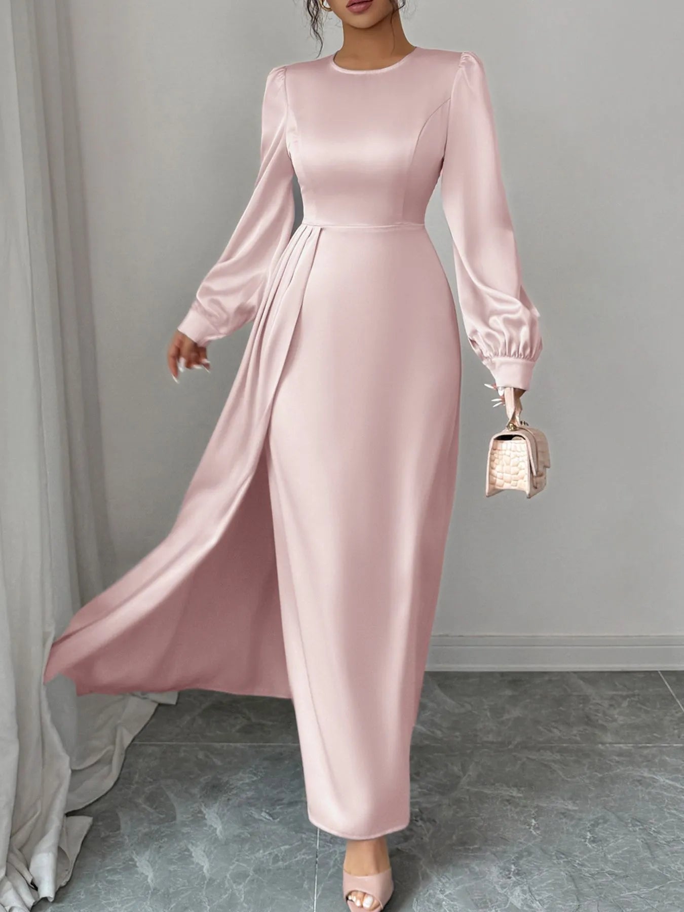 Pink satin dress with long sleeves on a neutral background