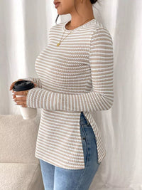 Person wearing a striped sweater holding a coffee cup against a white curtain background