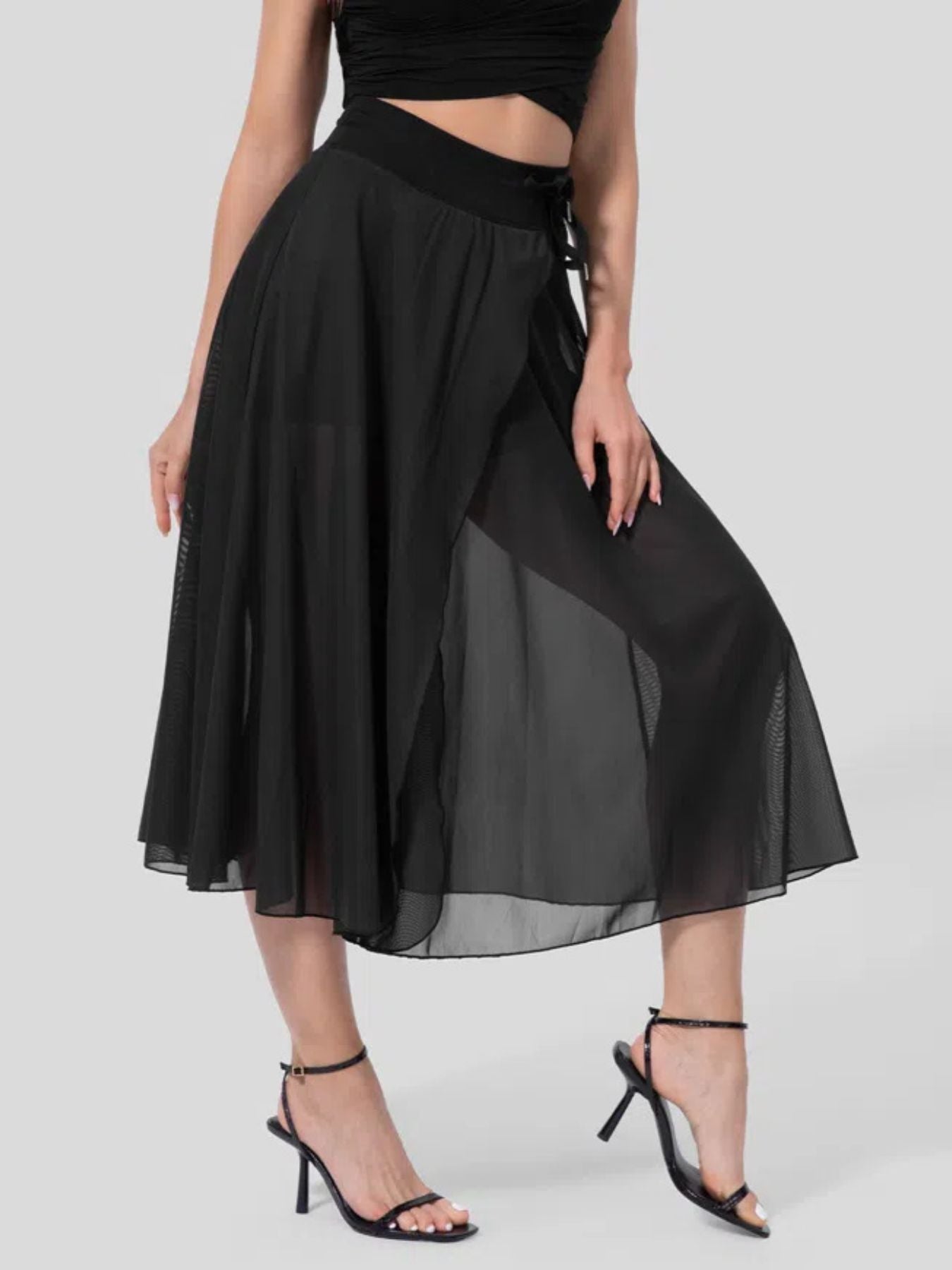 Black skirt worn by a person on a white background