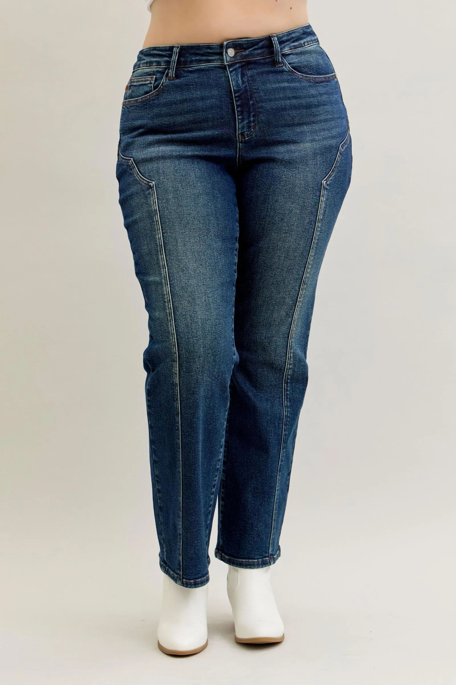 Blue jeans worn by a person on a plain background