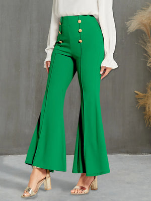 Green flared pants with gold buttons worn by a person against a gray background