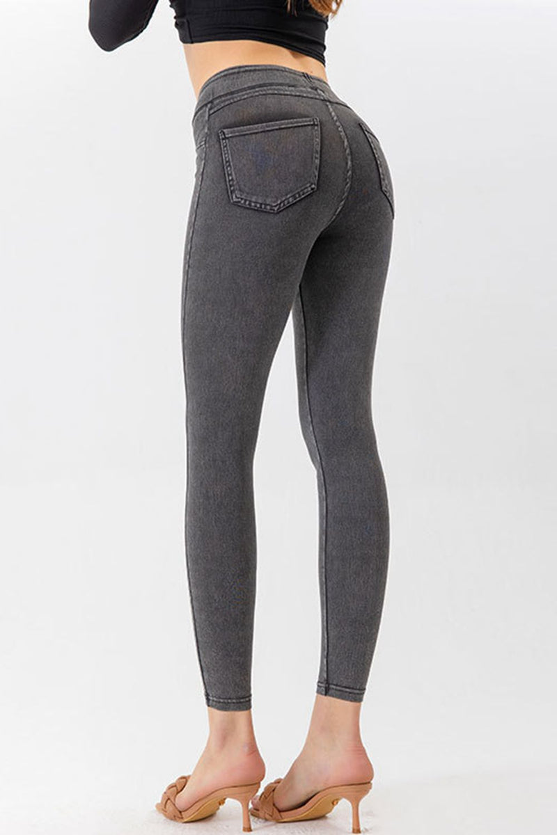 Gray leggings worn by a person on a white background