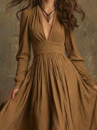Woman wearing a long brown dress with a textured background