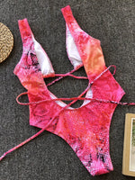 Pink sequin bikini top on a textured surface
