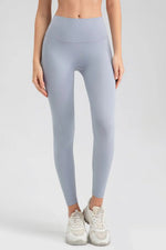Person wearing light gray leggings on a white background