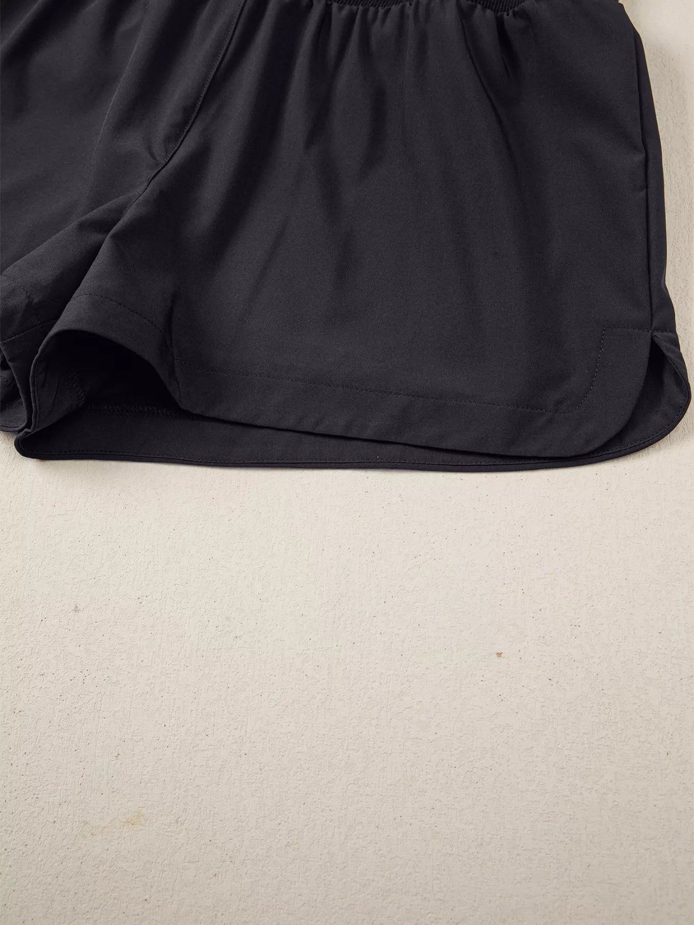 Black shorts on a beige background