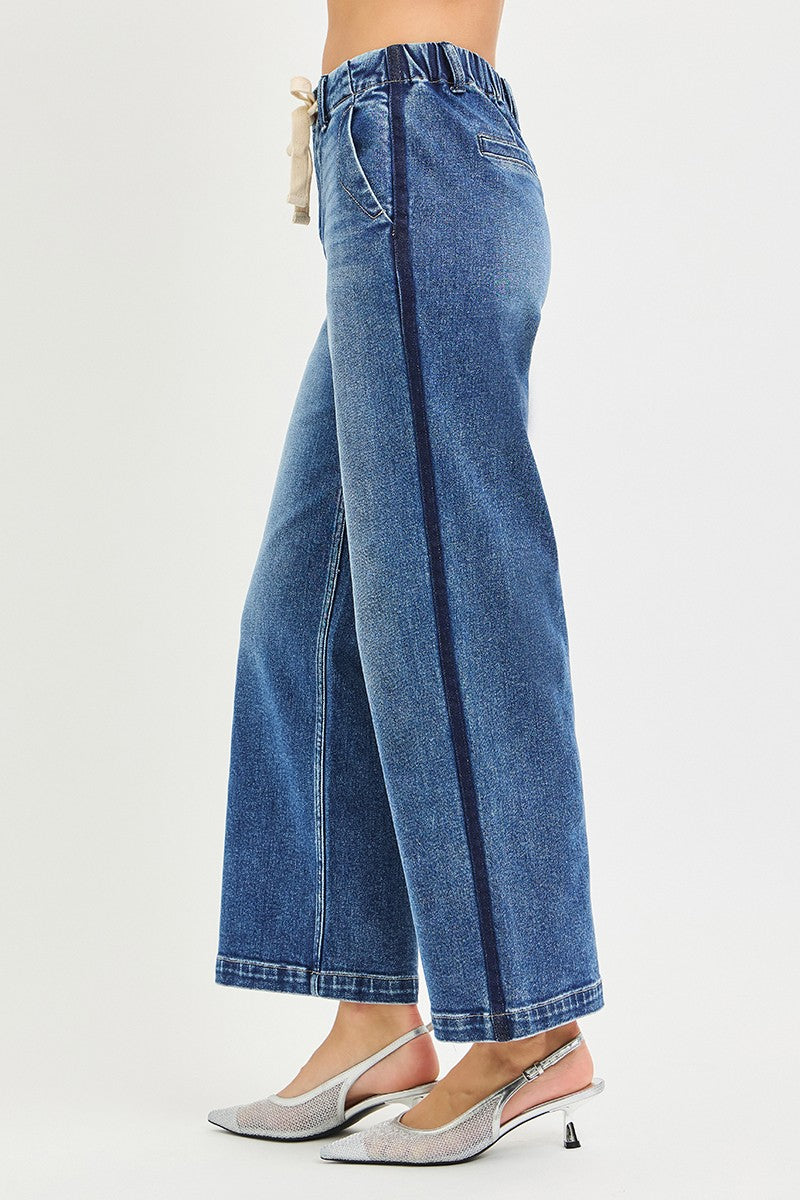 Blue jeans worn by a person on a white background