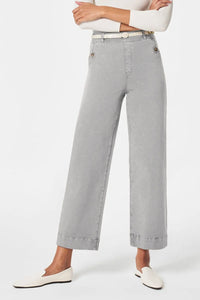 Person wearing light gray wide-leg pants on a white background