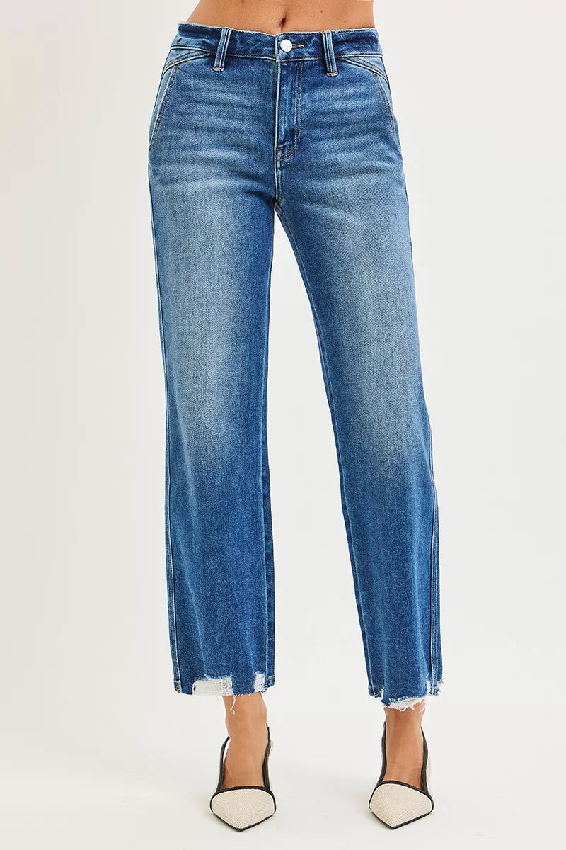 Blue jeans worn by a person on a white background