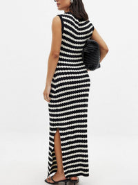 Woman wearing a black and white striped dress with a slit on a white background