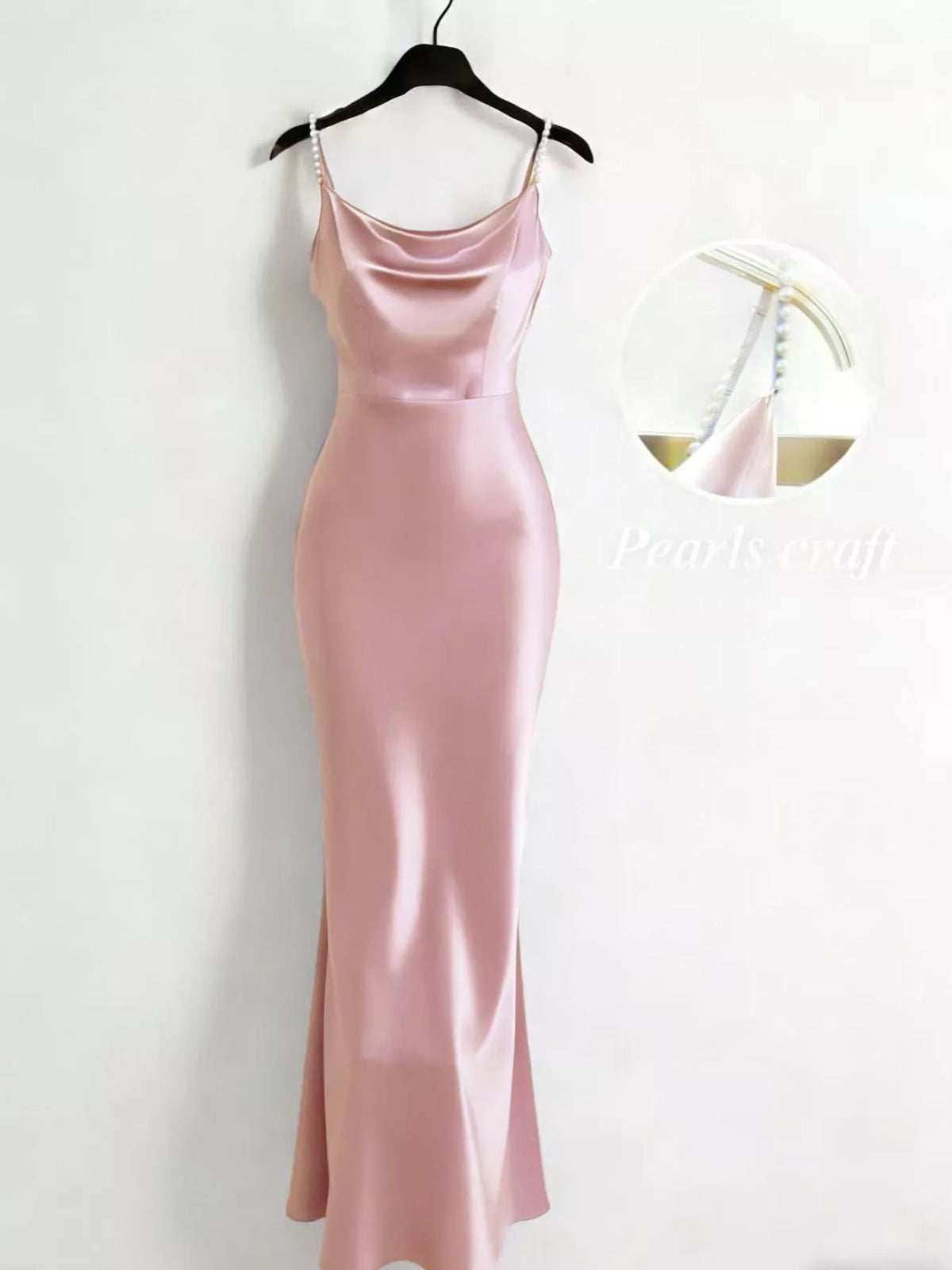 Pink slip dress on a hanger against a white background