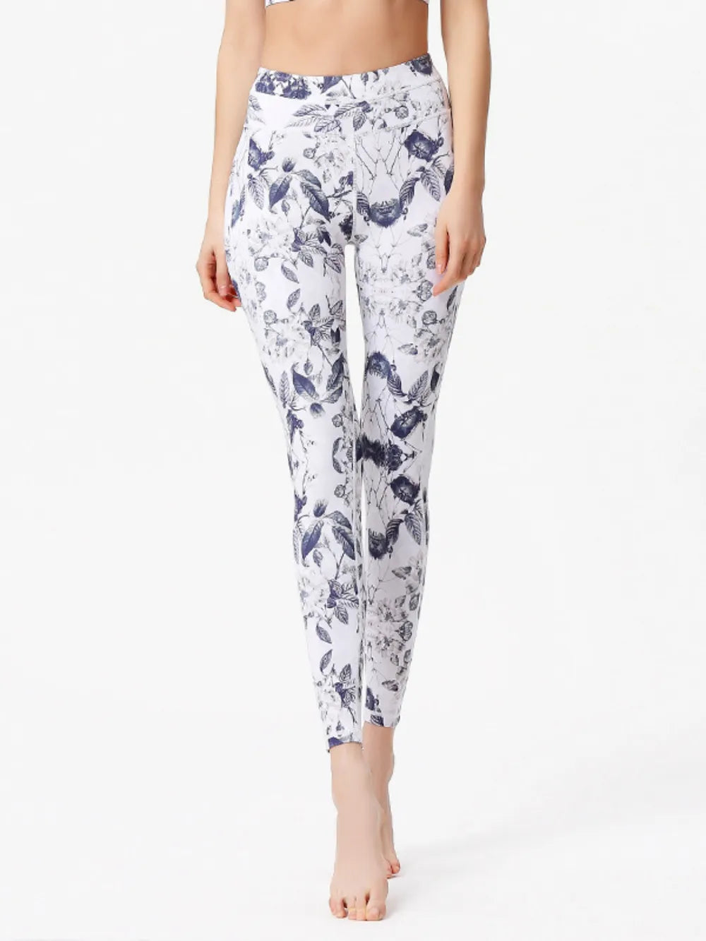 Person wearing floral leggings on a white background