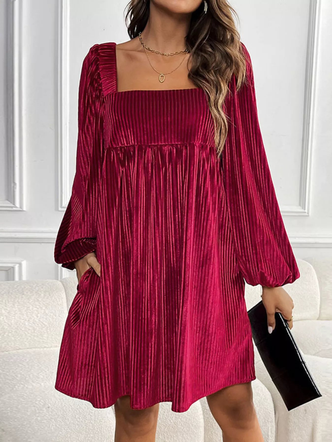 Red velvet dress worn by a person in an indoor setting
