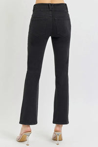 Black jeans worn by a person on a white background