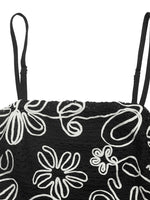 Black bag with white floral patterns on a white background