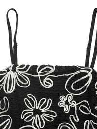 Black bag with white floral patterns on a white background