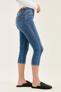 Person wearing blue jeans on a white background