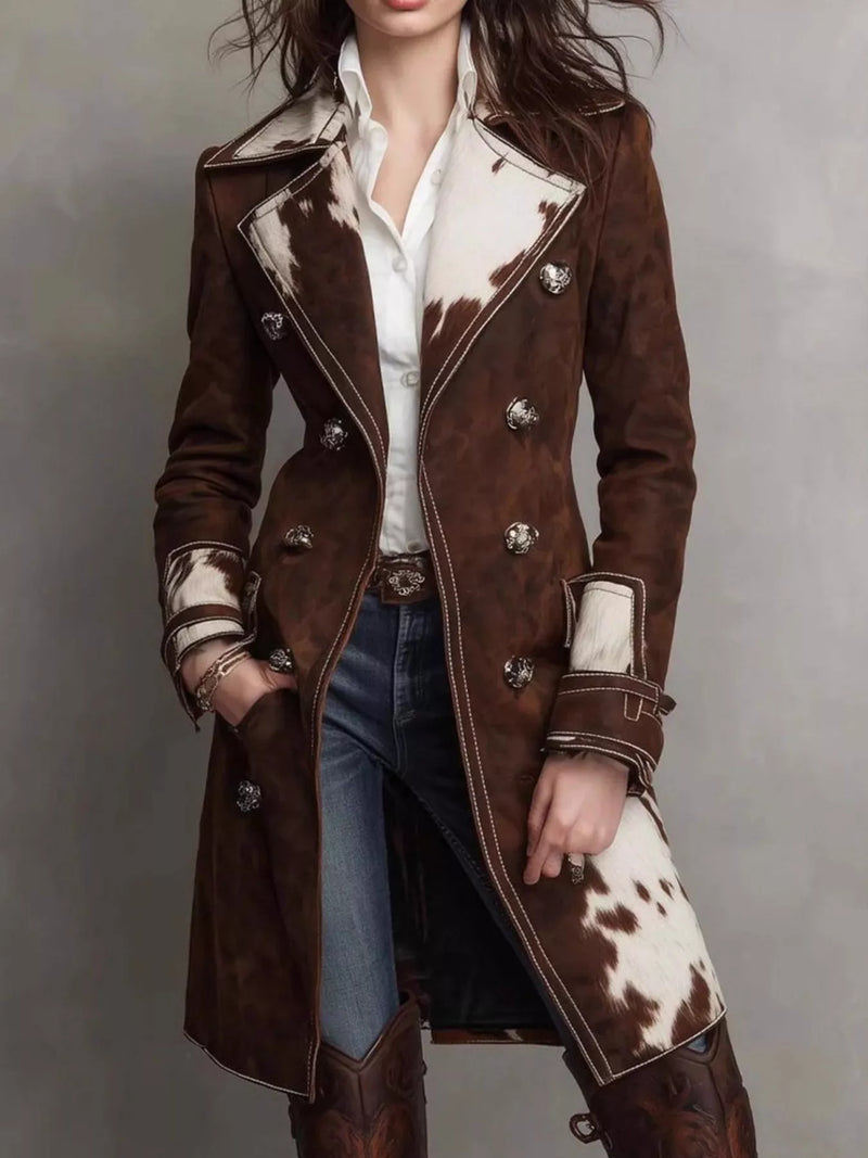 Person wearing a brown coat with cowhide pattern on a gray background