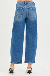 Blue jeans worn by a person on a white background