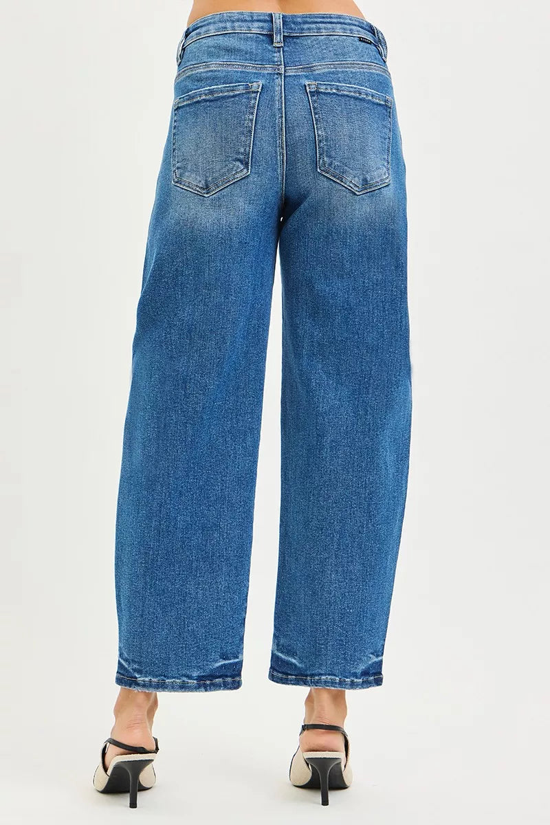 Blue jeans worn by a person on a white background