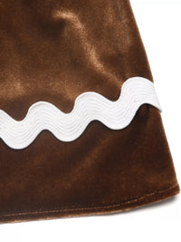 Brown fabric with white wavy line trim on a white background
