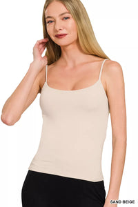 Woman wearing a sand beige tank top on a white background